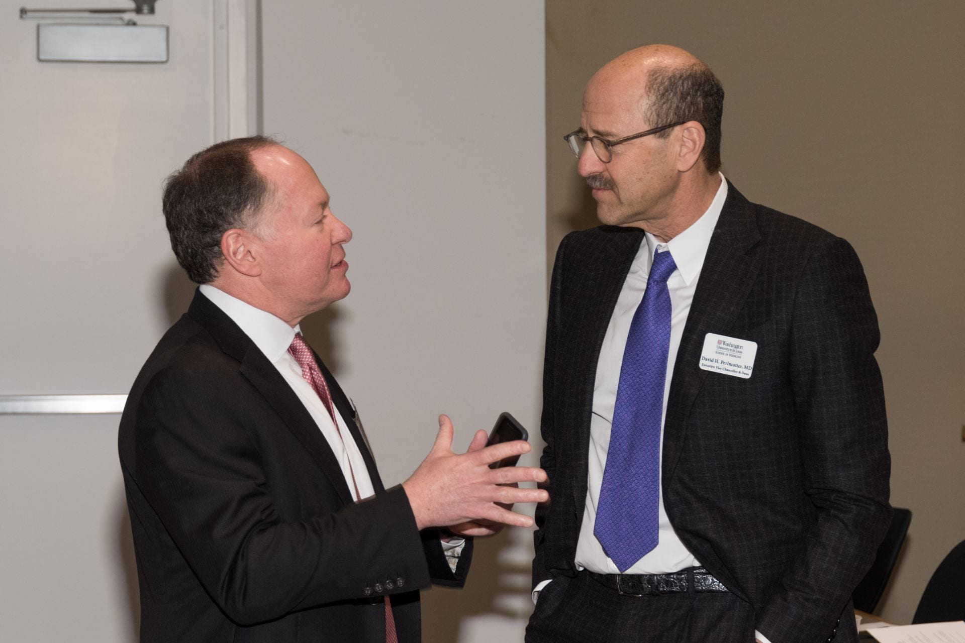 Mr. Andrew Bursky and Dean David Perlmutter confer before the symposium.