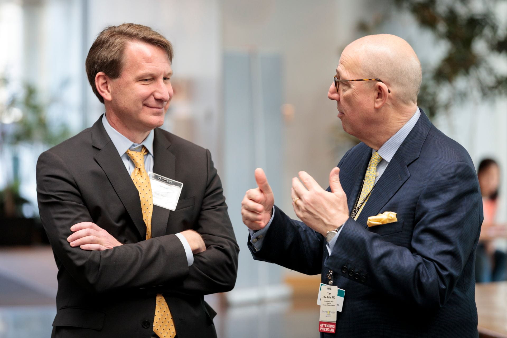 NCI Director Norman E. "Ned" Sharpless, MD, left, talks with Siteman Cancer Center Director Timothy Eberlein, MD, before the The Burksy Center at Washington University 2nd Annual Symposium