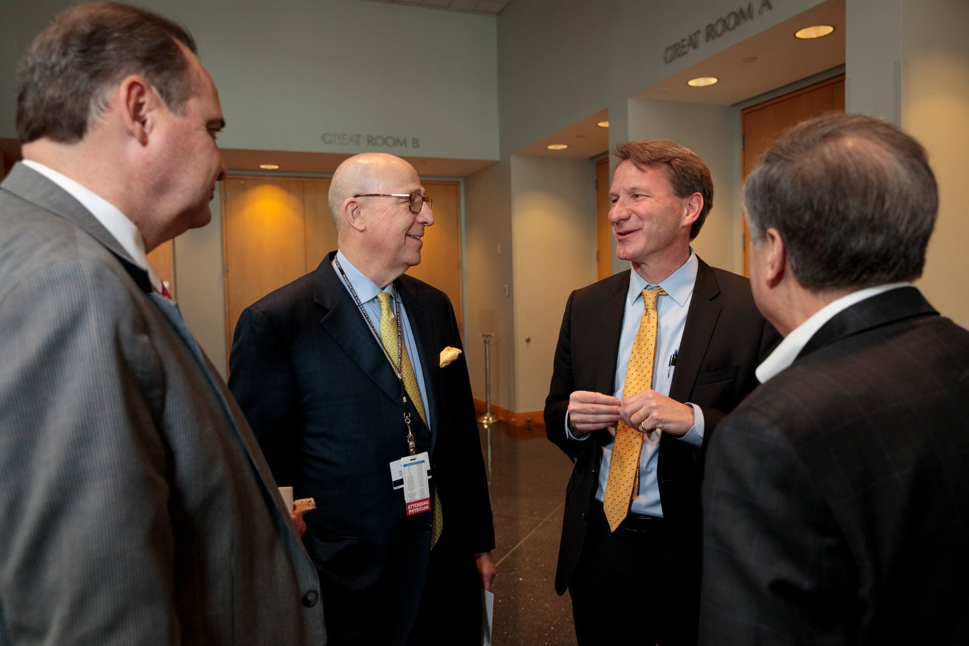 Dennis Hallahan, MD, Chairman of the Department of Radiation Oncology, left, Timothy Eberlein, MD, Director of Siteman Cancer Center, NCI Director Norman E. "Ned" Sharpless, MD, and Robert Schreiber, PhD, talk during a break.